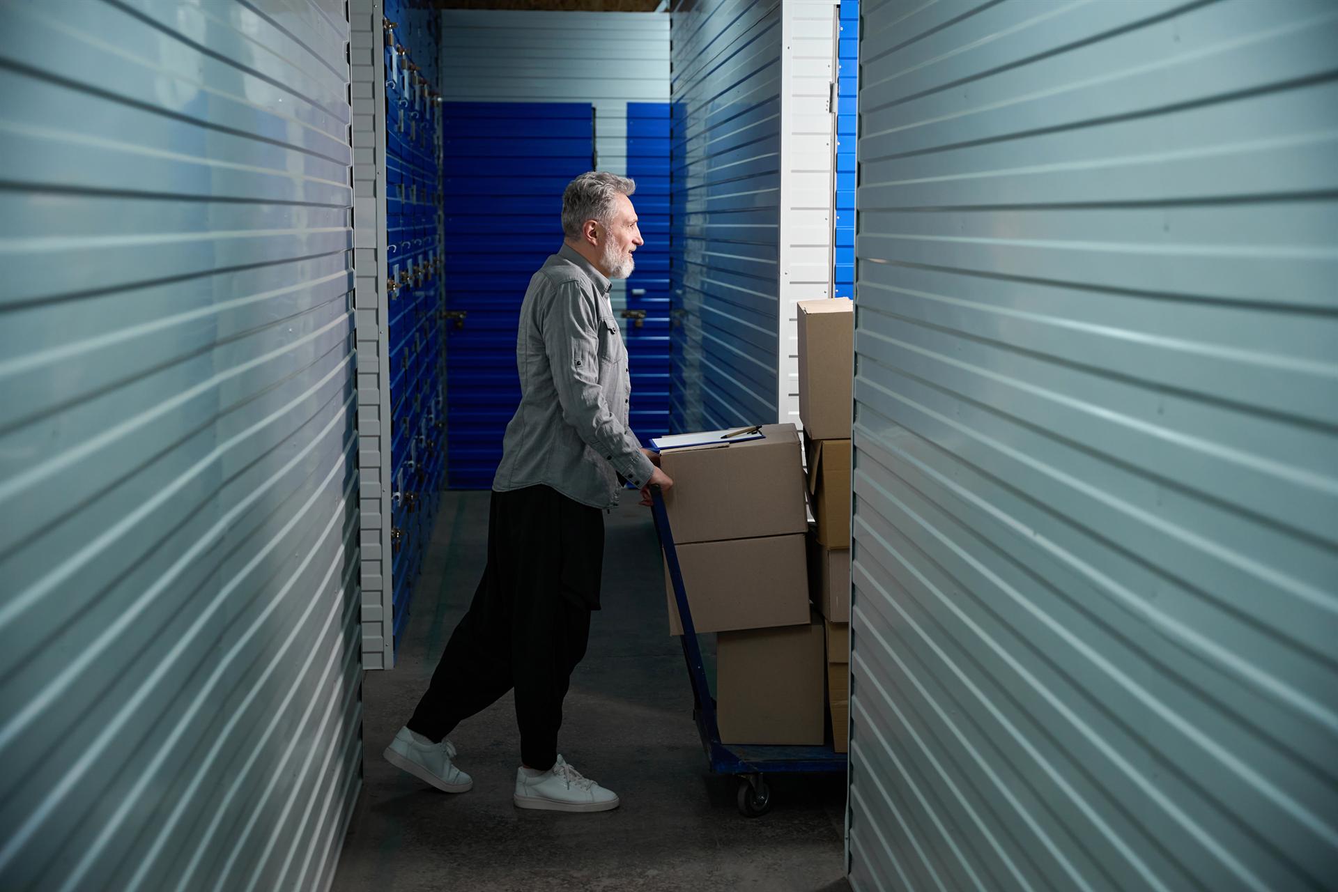 A customer moving boxes on a cart at StorCo